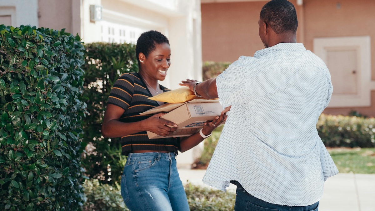 A customer receiving her delivery at home